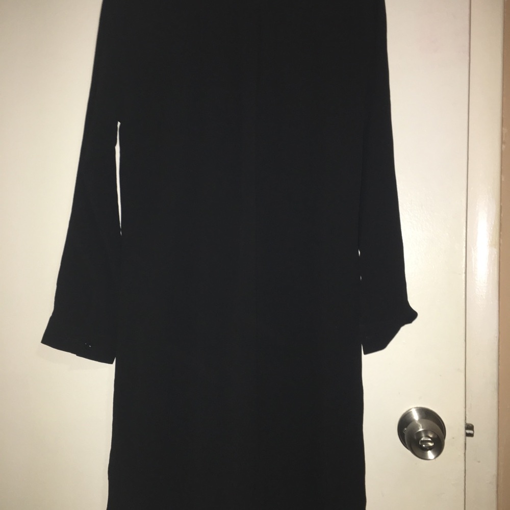a mini black dress with silver beats on it